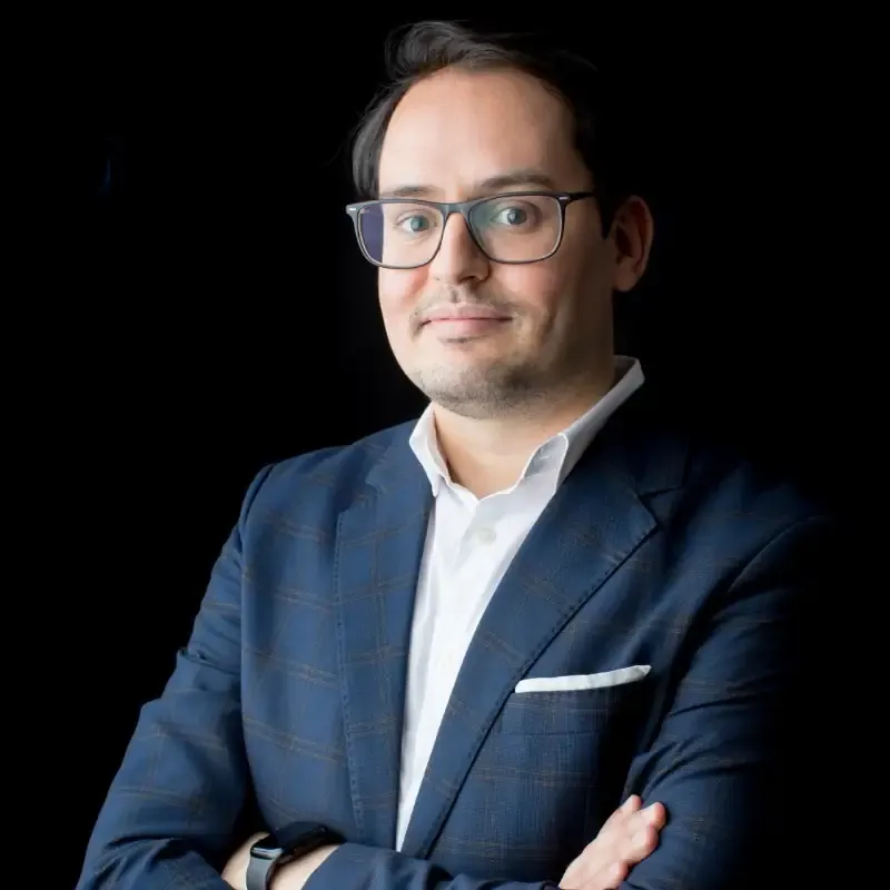 Abdelhamid, founder of WeFix404, in a navy blazer with arms crossed